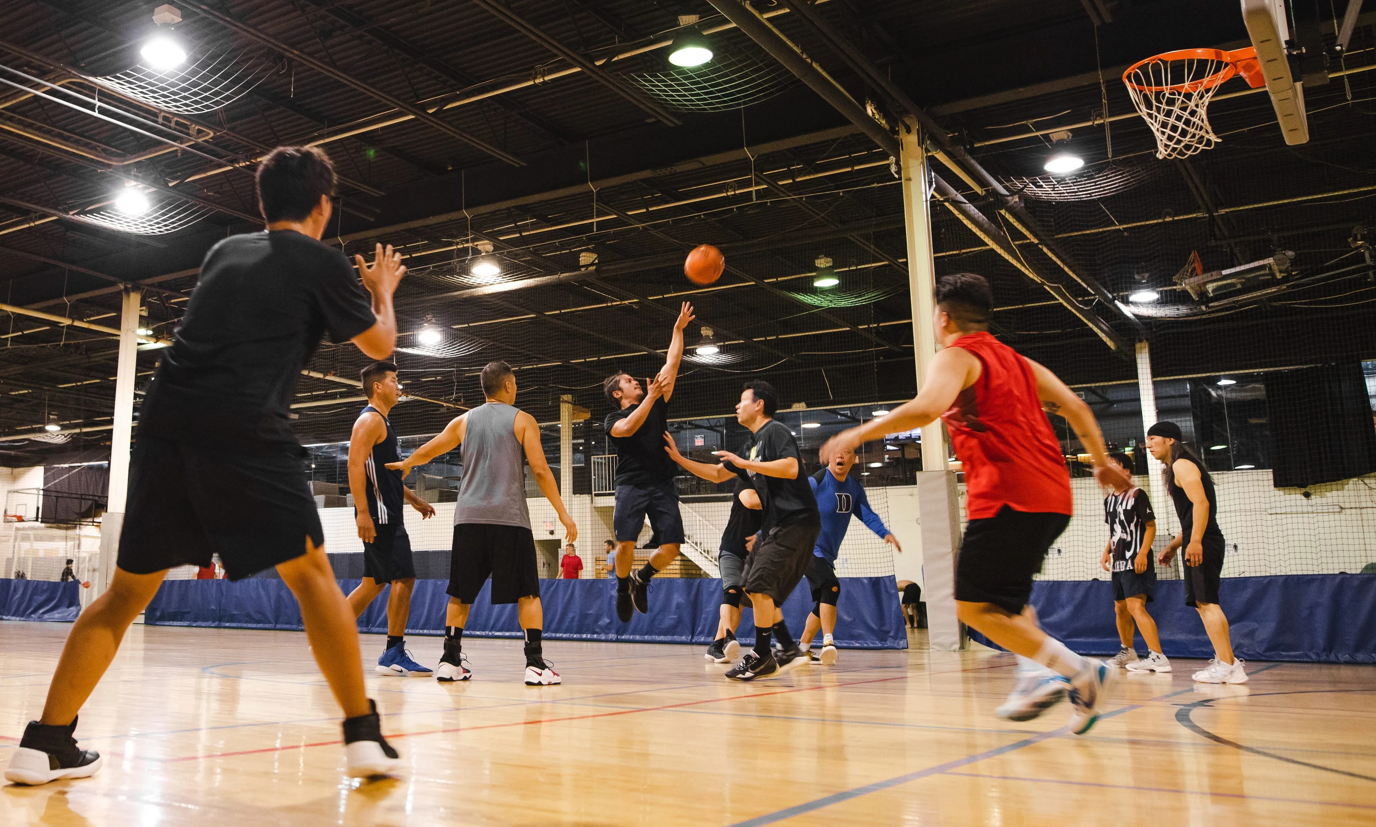 People playing indoor basketball