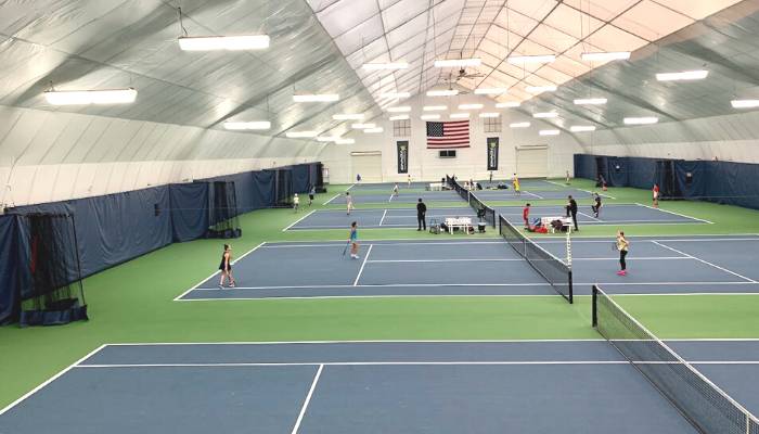 People playing indoor tennis